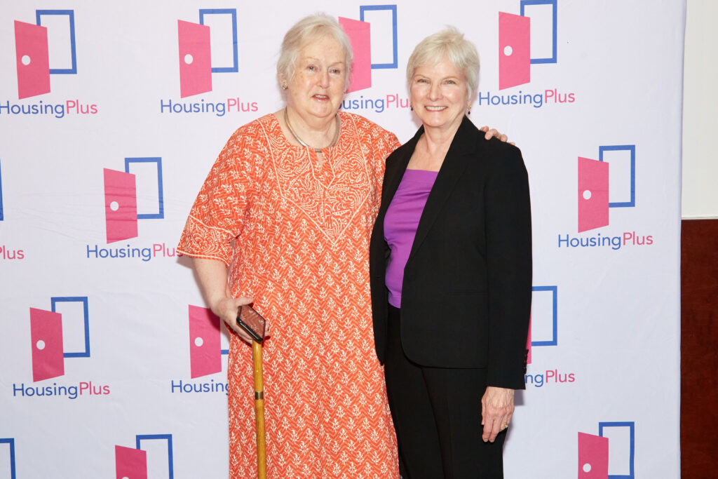 Two women smile at camera