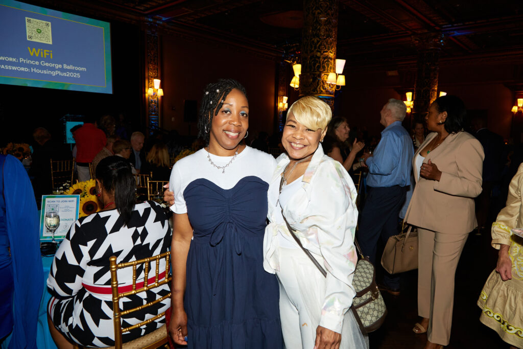 A tenant and another member of staff at an event.