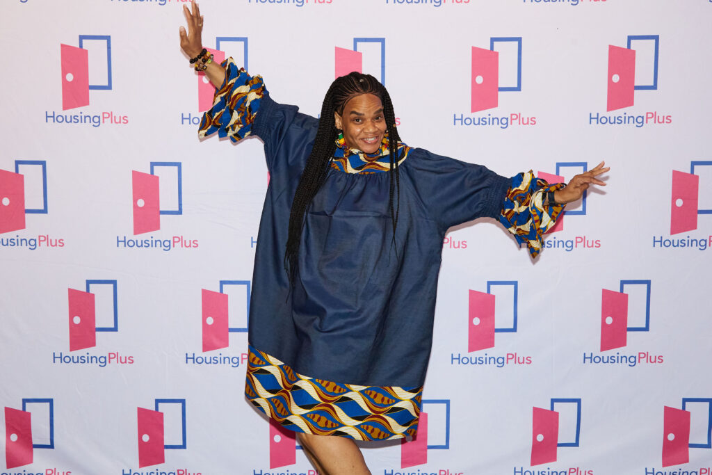 A woman with long hair does a jaunty pose