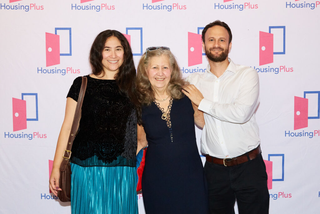 An older women and two younger people flanking her