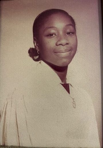 A picture of a young woman in a light colored gown, in sepia tone.