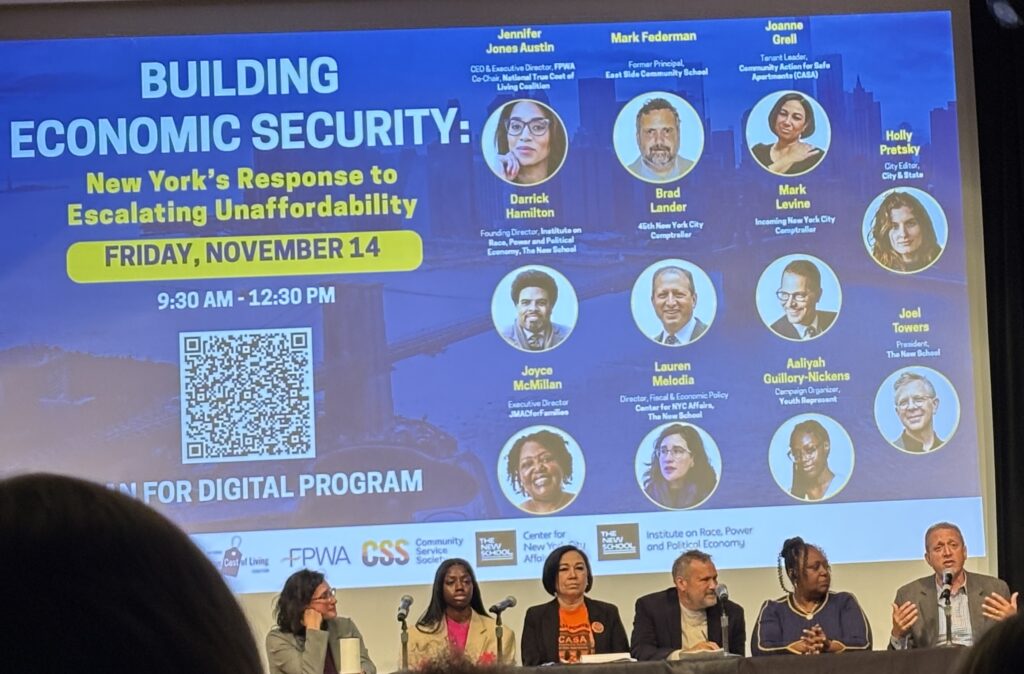 A group of six people is seated behind a table. There are four microphones set up in front of them. From left to right they are Lauren Melodia, Aaliyah Guillory-Nickens, Mark Federman, Joyce McMillan, and Brad Lander.